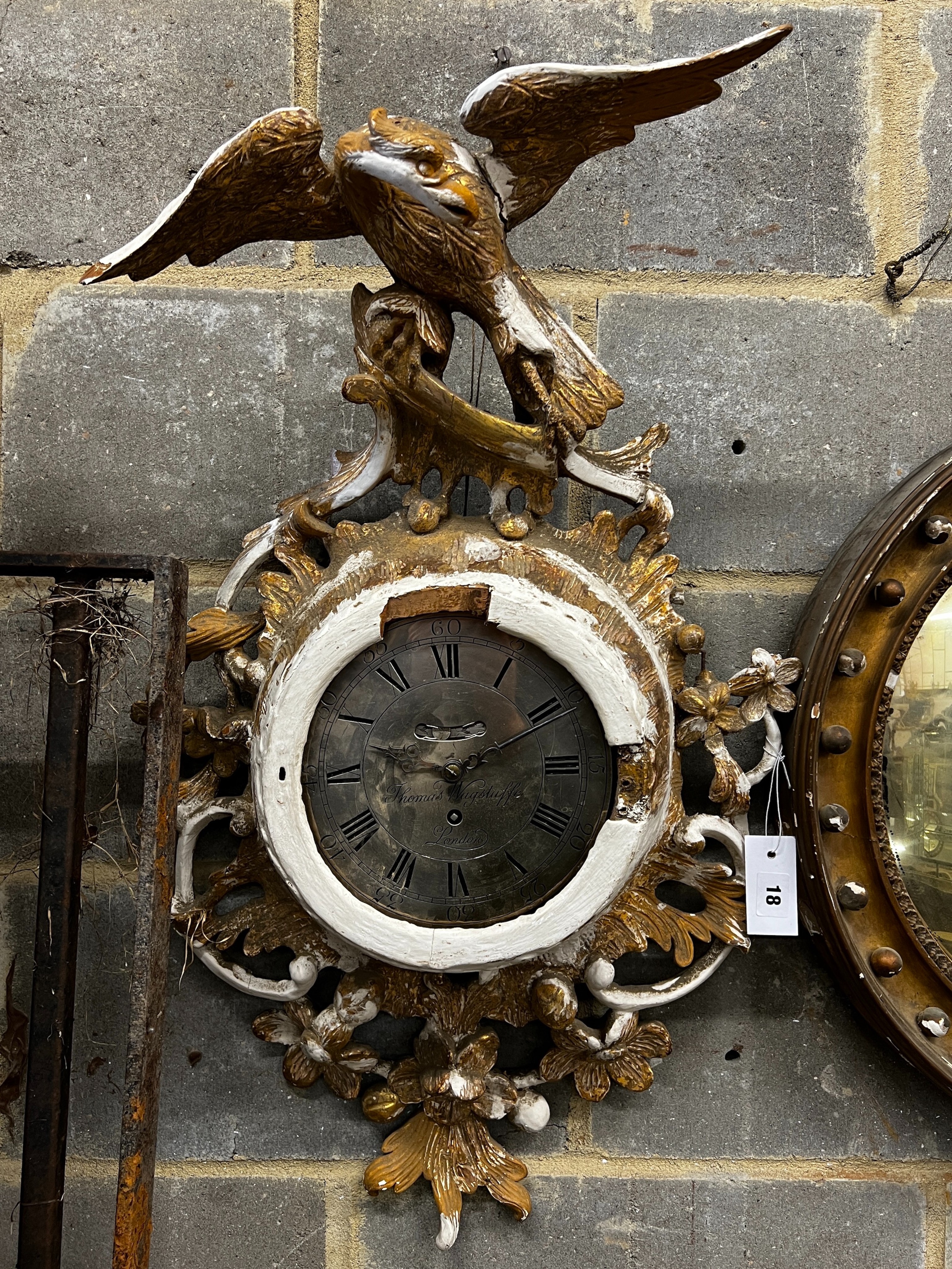 An early 19th century carved giltwood single fusee wall timepiece, silvered dial marked Thomas Wagstaffe, London. Case in need of restoration, height 78cm